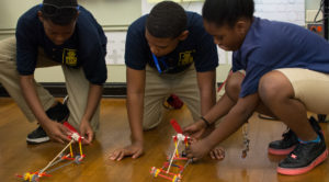 Kids designing toy cars to meet specs