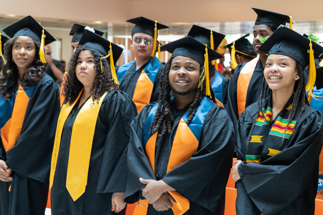 main image for the Dearborn STEM Academy website page featuring students in graduation caps and gowns